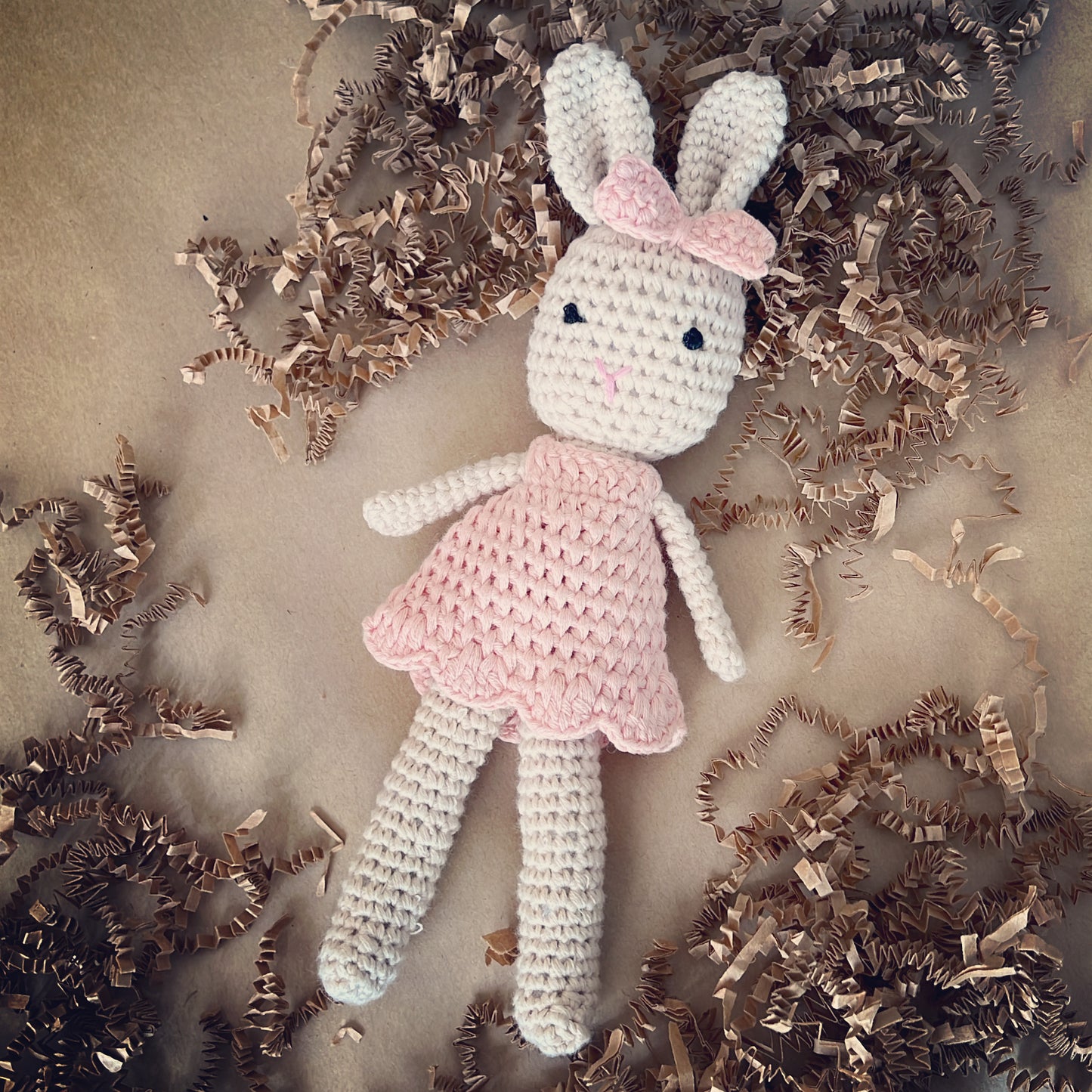 Crochet handmade bunny doll dressed in a crochet pink dress and a matching pink crochet bow, made with organic cotton yarn. This cute crochet bunny is the cutest addition to a baby shower gift, a memorable newborn gift for years to keep