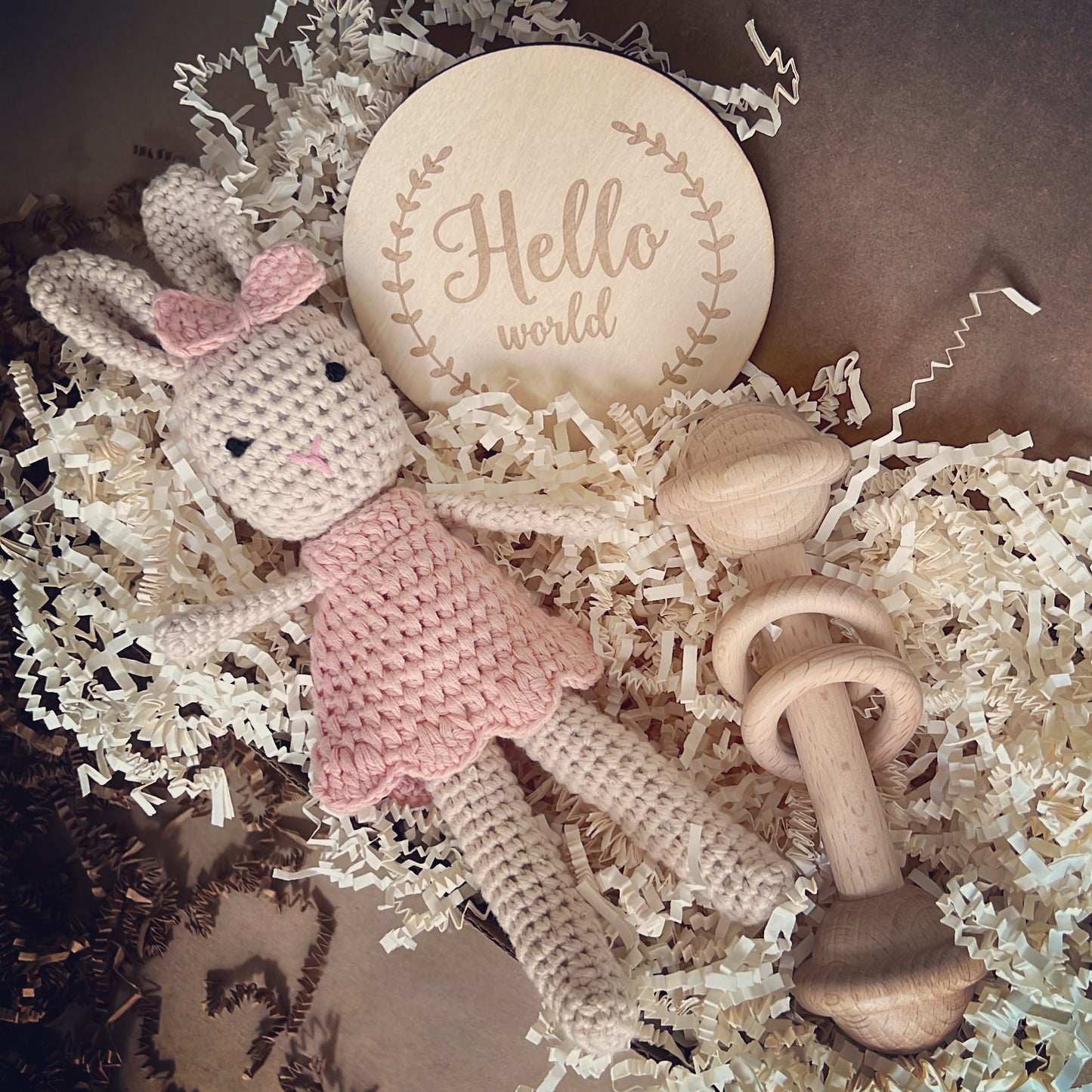 Baby Shower gift box that includes Crochet handmade bunny doll dressed in a crochet pink dress and a matching pink crochet bow, made with organic cotton yarn this cute box also includes a beechwood baby toy.This cute crochet toy bunny bundle is the cutest baby shower gift a newborn could keep for years