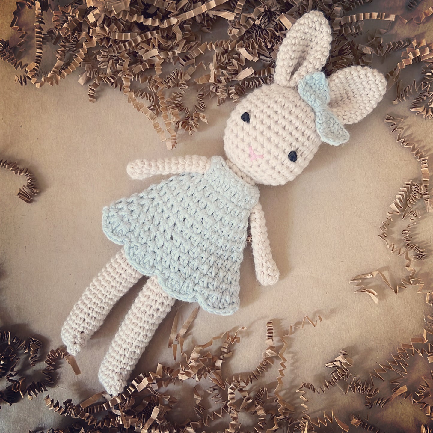 Crochet handmade bunny doll dressed in a crochet blue dress and a matching blue crochet bow, made with organic cotton yarn. This cute crochet bunny is the cutest addition to a baby shower gift, a memorable newborn gift for years to keep